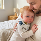 Drooling teething baby wearing a Bubzies bandana bib
