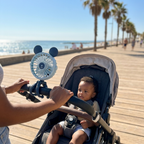 Octopus stroller fan clipped on during a seaside walk keeping baby cool